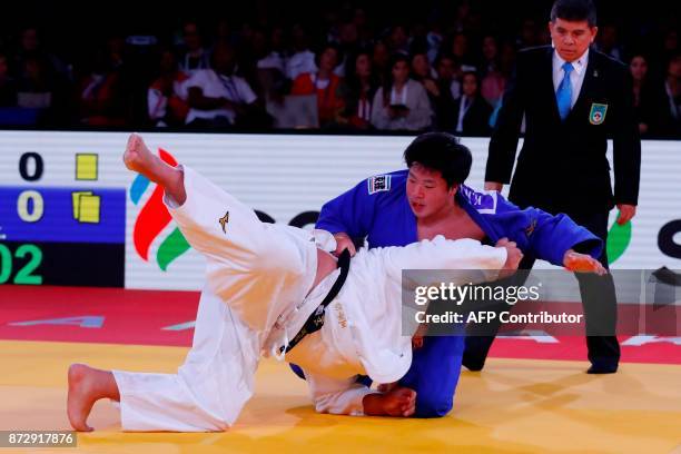 Japan's Takeshi Ojitani competes against his countryman Kokoro Kageura during their men's bronze medal judo contest at the Judo World Championships...