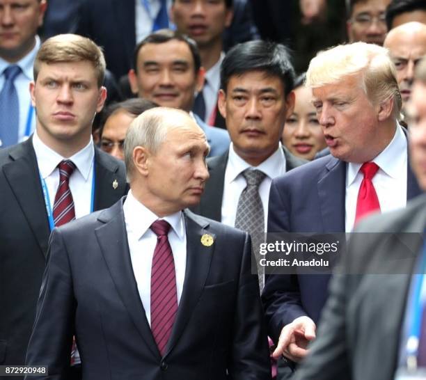 Russia's President Vladimir Putin and US President Donald Trump are seen during a photo session of world leaders on the closing day of the 25th APEC...