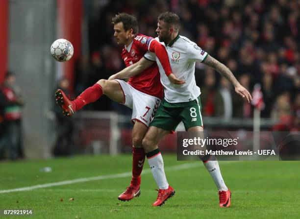 William Kvist of Denmark and Daryl Murphy of the Republic of Ireland battle for possession during the FIFA 2018 World Cup Qualifier Play-Off: First...