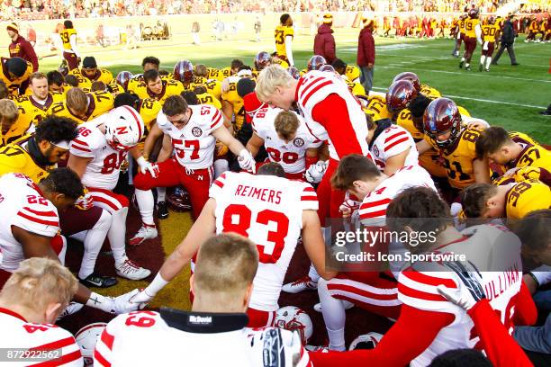 The Nebraska Cornhuskers and Minnesota Golden Gophers come together for a prayer after the Big Ten Conference game between the Nebraska Cornhuskers...