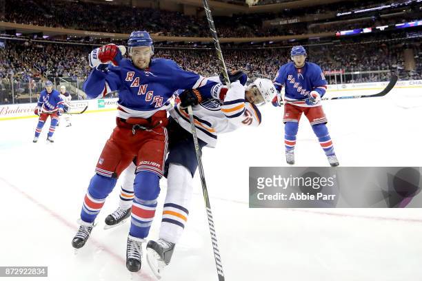 Kevin Shattenkirk of the New York Rangers shoves Darnell Nurse of the Edmonton Oilers in the third period during their game at Madison Square Garden...