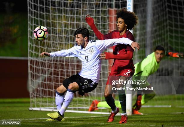 Leon Dajaku of Germany is tackled by Tomas Tavares of Portugal during the International Match between Germany U17 and Portugal U17 at St Georges Park...