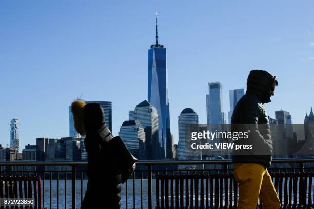 People commute from New Jersey to New York as the skyline of New York city and One World Trade Center are seen along Hudson river during low...