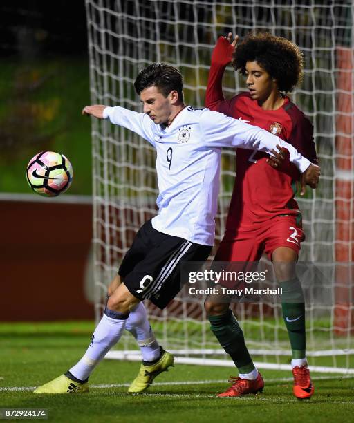 Leon Dajaku of Germany is tackled by Tomas Tavares of Portugal during the International Match between Germany U17 and Portugal U17 at St Georges Park...