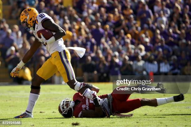 Stephen Sullivan of the LSU Tigers is tackled by Henre' Toliver of the Arkansas Razorbacks at Tiger Stadium on November 11, 2017 in Baton Rouge,...