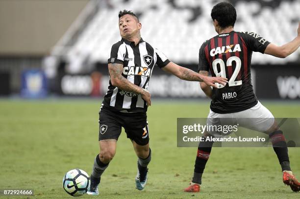 Leonardo Valencia of Botafogo struggles for the ball with Pablo of Atletico PR during the match between Botafogo and Atletico PR as part of...