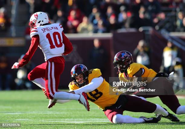 Ryan Santoso of the Minnesota Golden Gophers attempts the tackle on JD Spielman of the Nebraska Cornhuskers in the fourth quarter against the...