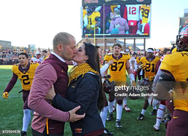 Head coach P.J. Fleck of the Minnesota Golden Gophers kisses his wife Heather Fleck on the field after the game at TCF Bank Stadium on November 11,...