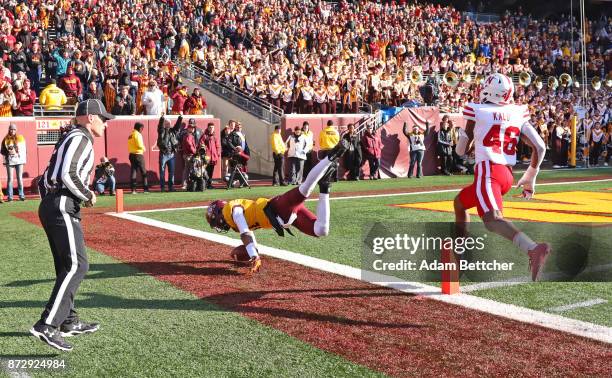 Demry Croft of the Minnesota Golden Gophers gets pushed out of bounds by Joshua Kalu in the fourth quarter at TCF Bank Stadium on November 11, 2017...