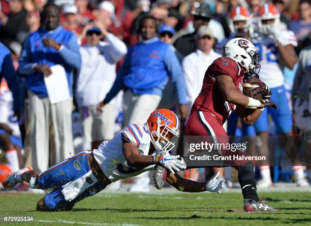 Marco Wilson of the Florida Gators dives to tackle A.J. Turner of the South Carolina Gamecocks during their game at Williams-Brice Stadium on...