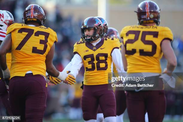 Emmit Carpenter of the Minnesota Golden Gophers celebrates an extra point in the fourth quarter against the Minnesota Golden Gophers at TCF Bank...