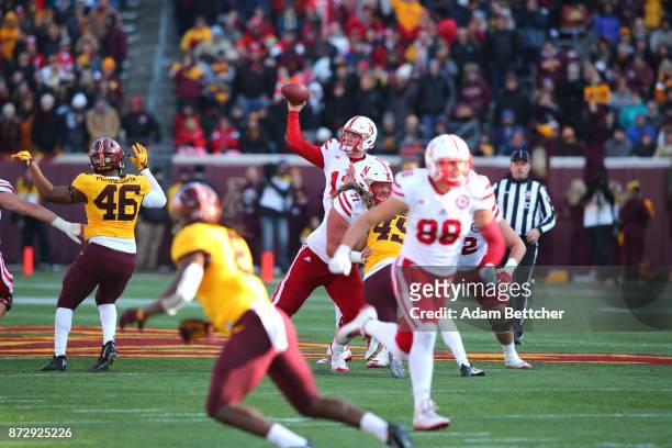 Patrick O'Brien of the Nebraska Cornhuskers passes the ball for a first down in the third quarter against the Minnesota Golden Gophers at TCF Bank...