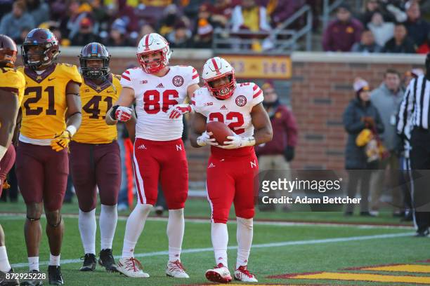 Jack Stoll and Devine Ozigbo of the Nebraska Cornhuskers celebrate a touchdown in the fourth quarter against the Minnesota Golden Gophers at TCF Bank...
