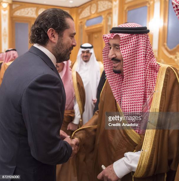 King of Saudi Arabia Salman bin Abdulaziz Al Saud shakes hands with Former Prime Minister of Lebanon Saad Hariri , who resigned recently, at King...