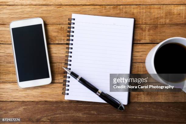 blank white diary with pen, coffee and smart phone - notepad table stock pictures, royalty-free photos & images