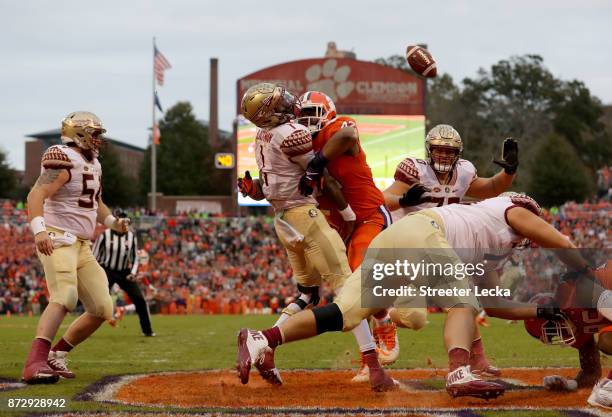 Christian Wilkins of the Clemson Tigers hits James Blackman of the Florida State Seminoles in the endzone during their game at Memorial Stadium on...