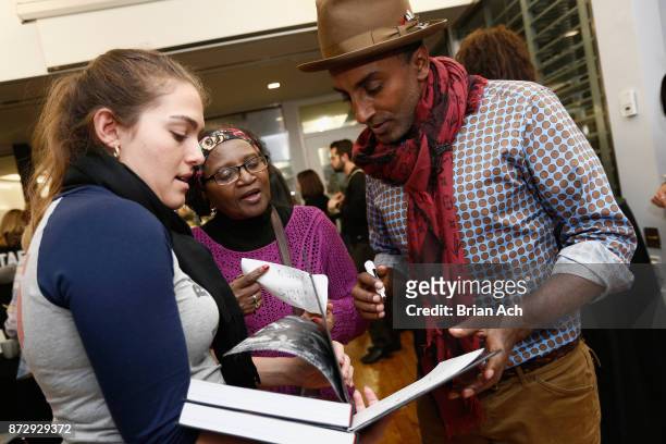 Chef Marcus Samuelsson signs a student's cook book at Food Network Magazine's 2nd Annual Cooking School featuring Marcus Samuelsson on November 11,...