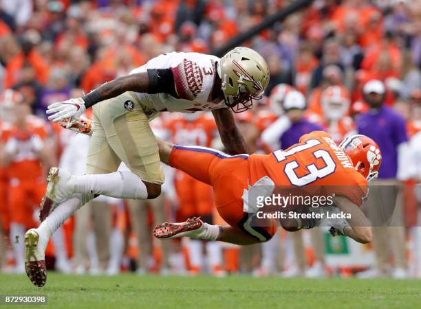 Hunter Renfrow of the Clemson Tigers tries to make a catch against Derwin James of the Florida State Seminoles during their game at Memorial Stadium...