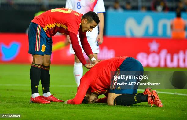 Spain's forward Alvaro Morata reacts next to Spain's midfielder Thiago after scoring a goal during the international friendly football match Spain...