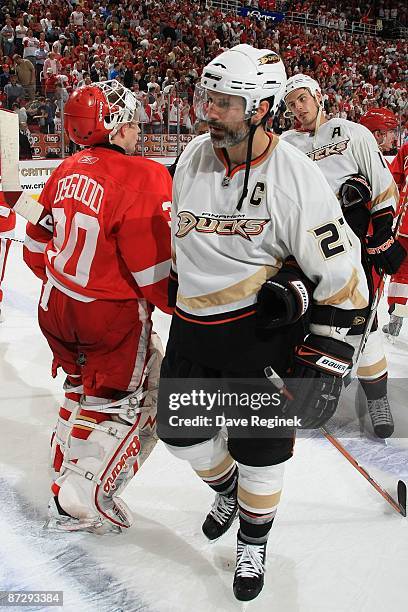 Chris Osgood of the Detroit Red Wings shakes hands with Scott Niedermayer and Ryan Getzlaf of the Anaheim Ducks after Game Seven of the Western...