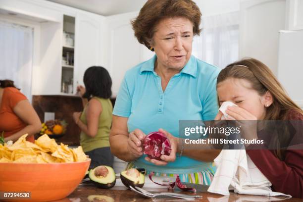 hispanic family cooking in kitchen - filipino family dinner stock-fotos und bilder