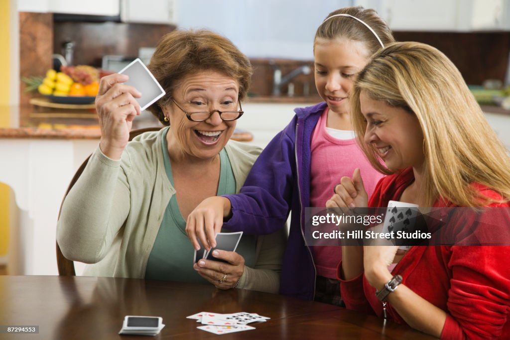 Hispanic family playing cards together