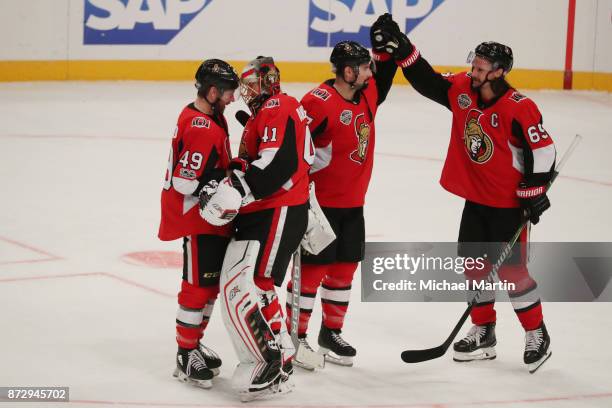 Christopher DiDomenico, goaltender Craig Anderson, Nate Thompson and Erik Karlsson of the Ottawa Senators celebrate the victory against the Colorado...