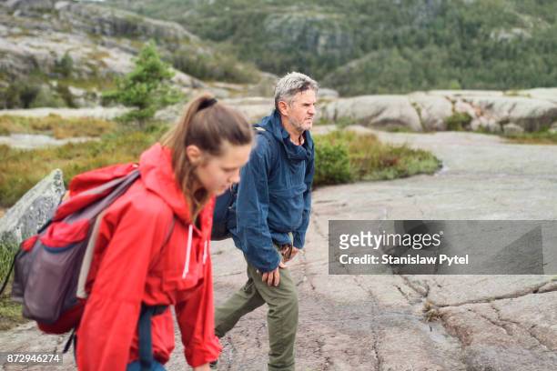 father with daughter hiking in norway mountains - senior man grey long hair stock pictures, royalty-free photos & images
