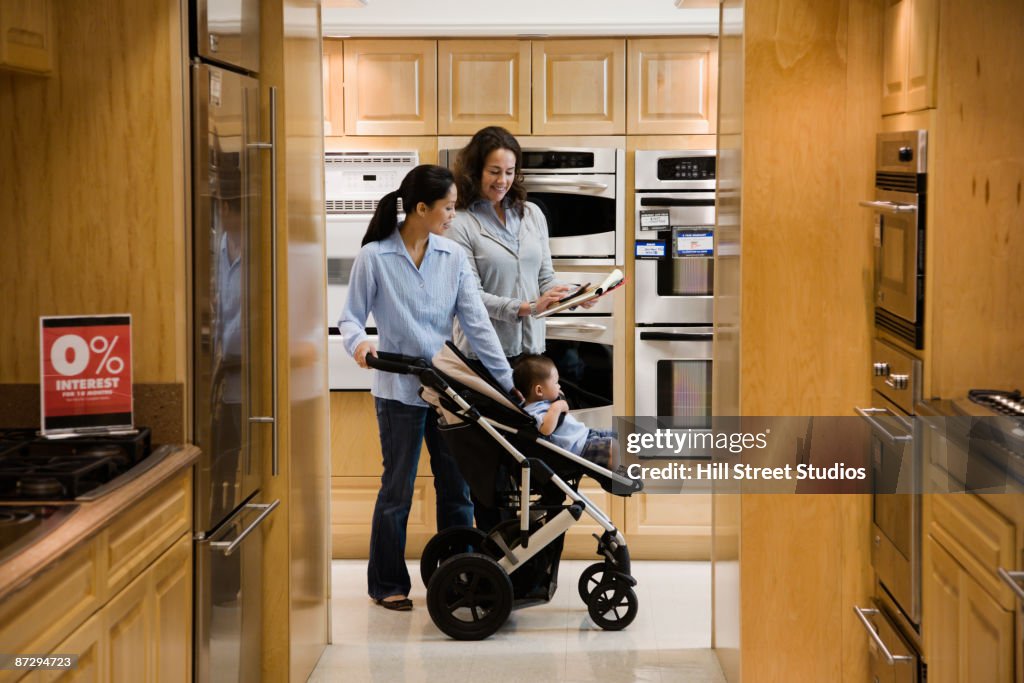 Saleswoman helping customer in appliance showroom