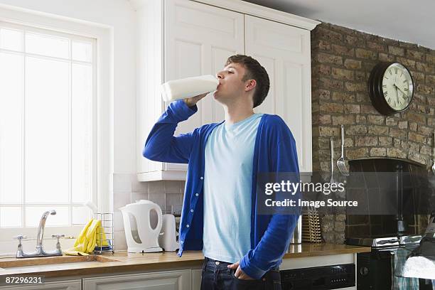 young man drinking milk - milk bottles stock pictures, royalty-free photos & images