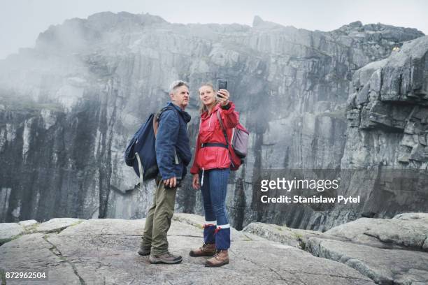 woman taking selfie with father in mountains - preikestolen bildbanksfoton och bilder