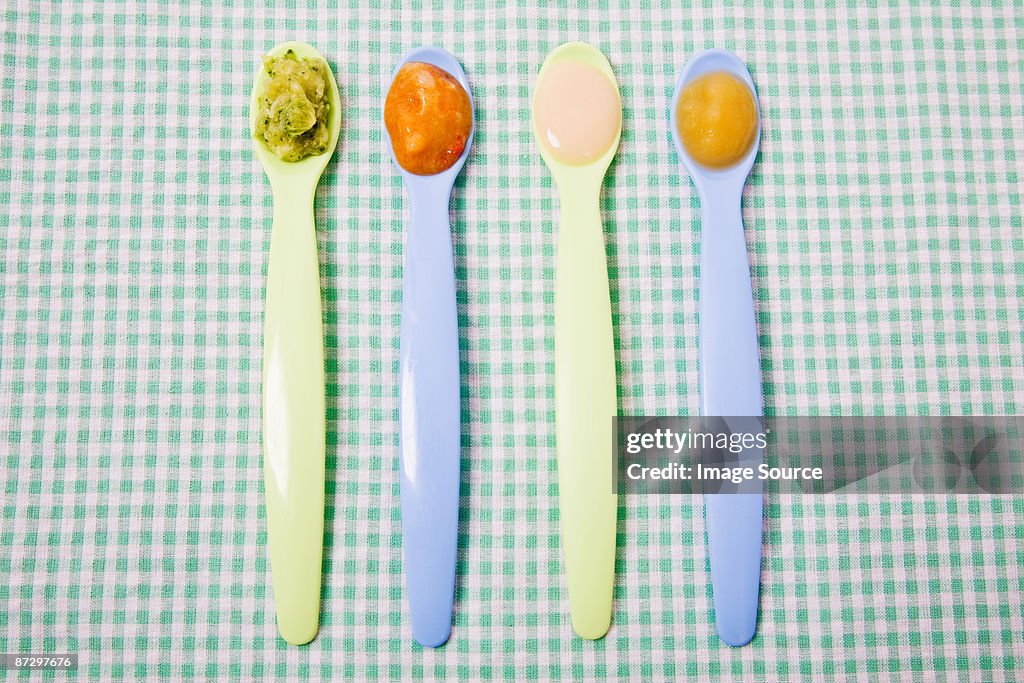 Baby food on spoons
