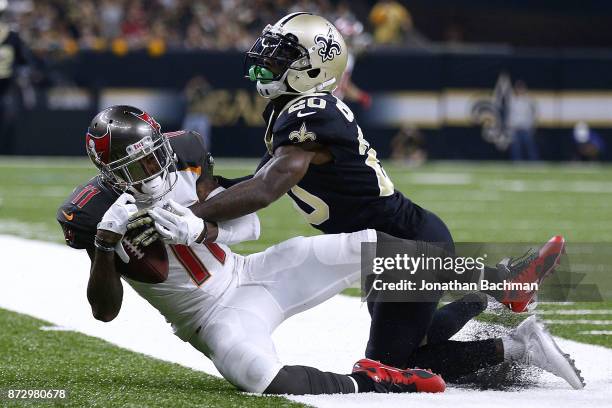 Ken Crawley of the New Orleans Saints forces DeSean Jackson of the Tampa Bay Buccaneers out of bounds during the first half of a game at...