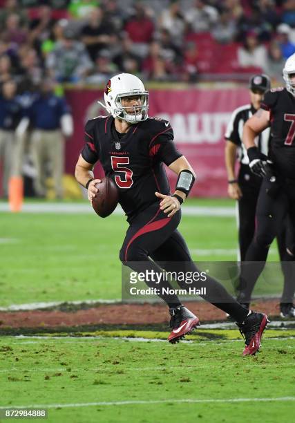 Drew Stanton of the Arizona Cardinals rolls out while looking to throw the ball against the Seattle Seahawks at University of Phoenix Stadium on...