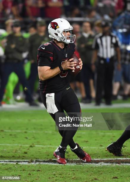 Drew Stanton of the Arizona Cardinals drops back while looking to throw the ball against the Seattle Seahawks at University of Phoenix Stadium on...