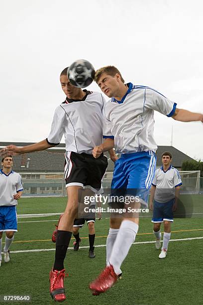 footballers heading ball - heading the ball stock pictures, royalty-free photos & images