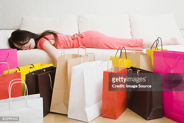 sleeping woman and shopping bags - alta moda fotografías e imágenes de stock