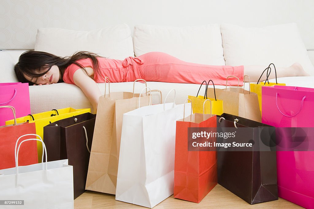 Sleeping woman and shopping bags