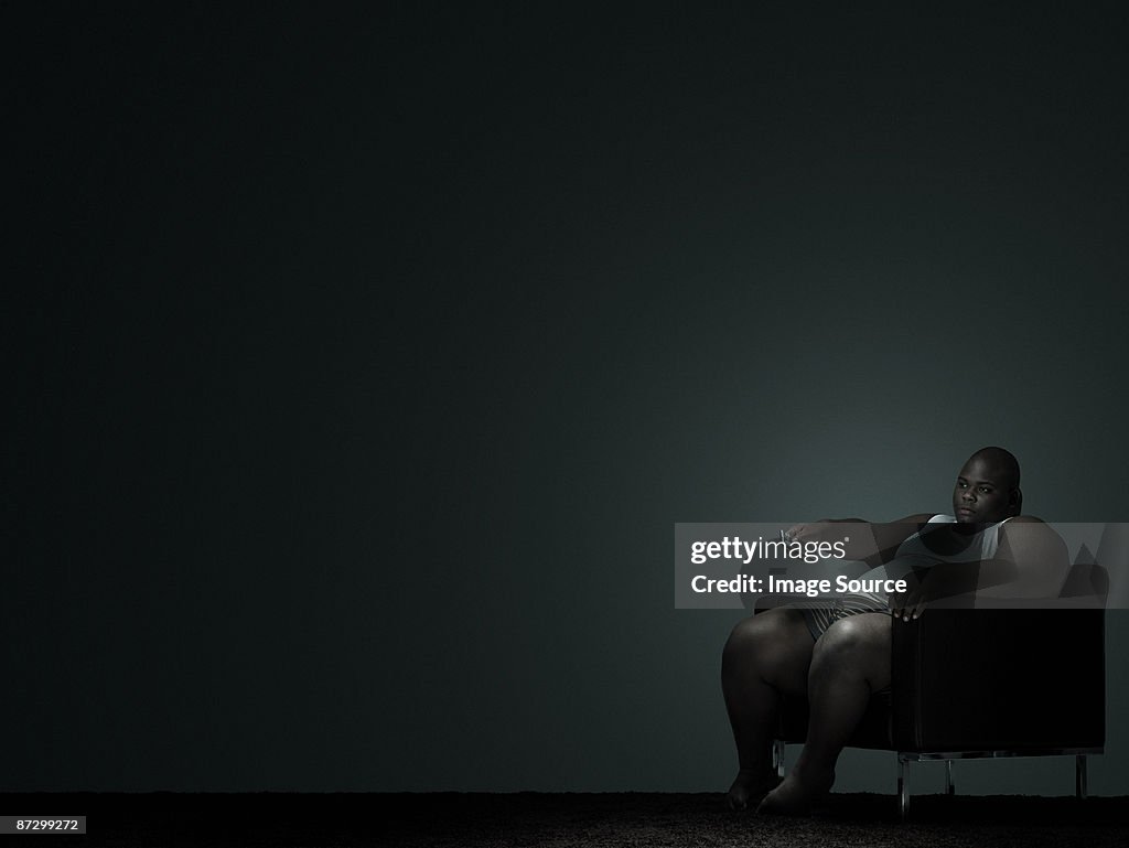 Overweight man watching television