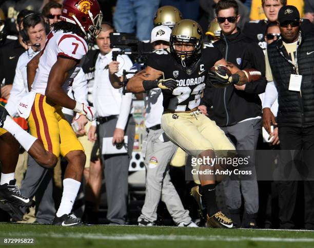 Colorado Buffaloes running back Phillip Lindsay gains first down yardage against USC Trojans safety Marvell Tell III in the first quarter at Folsom...
