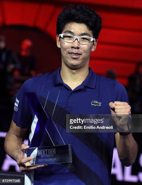 Hyeon Chung of South Korea celebrates with the trophy after victory against Andrey Rublev of Russia in the mens final on day 5 of the Next Gen ATP...