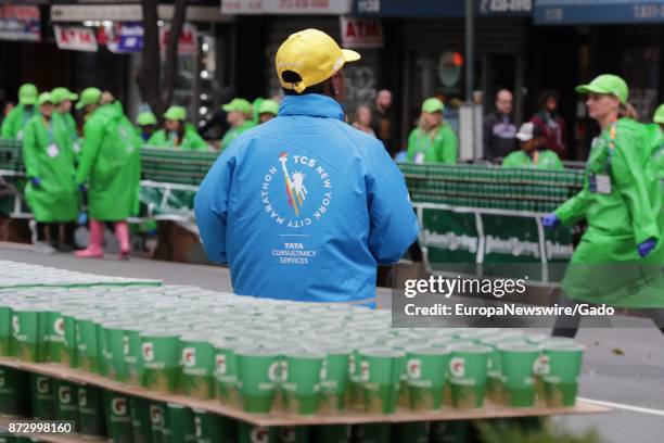 People cheer on the sidewalk and hand out gatorade as runners make their way in the New York Marathon in Manhattan, New York City, New York, November...
