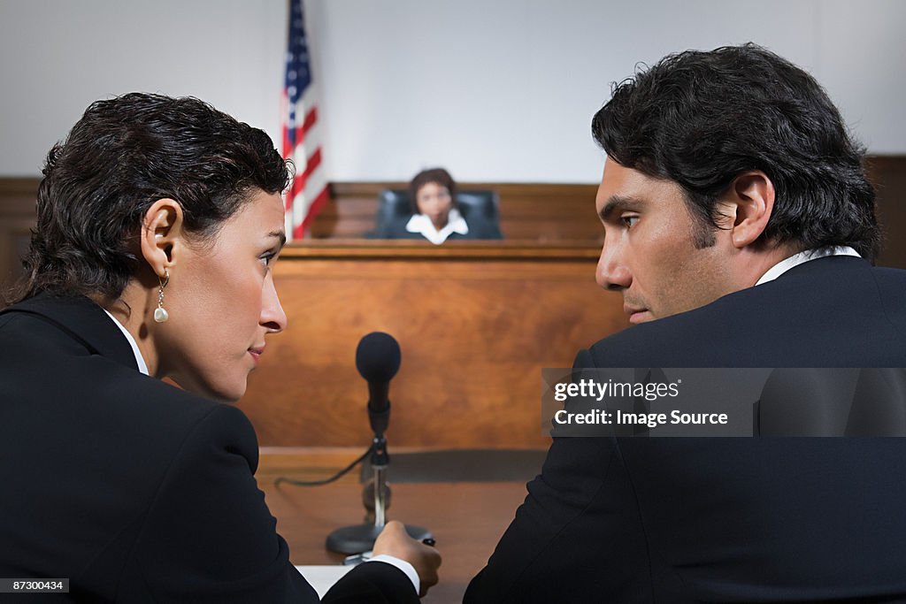 A lawyer and defendant talking