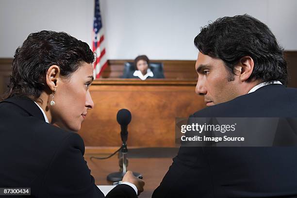 a lawyer and defendant talking - courtroom defendant stock pictures, royalty-free photos & images