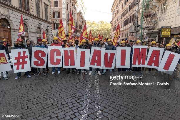 Supporters hold up letters of the alphabet that read, 'slaves never' during the demonstration against European Union politics, italian policies and...