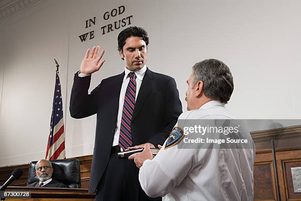 a witness swearing an oath - pledge stock pictures, royalty-free photos & images