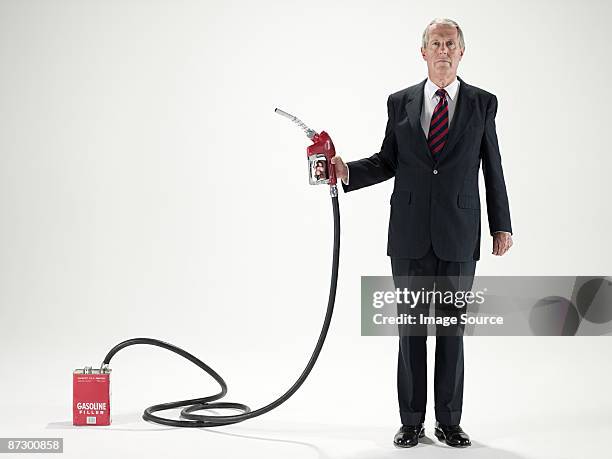 man holding a fuel pump - hose stockfoto's en -beelden