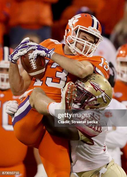 Hunter Renfrow of the Clemson Tigers makes a catch over A.J. Westbrook of the Florida State Seminoles during their game at Memorial Stadium on...