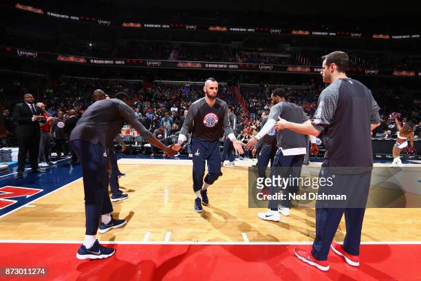 Marcin Gortat of the Washington Wizards high fives his teammates before the game against the Atlanta Hawks on November 11, 2017 at Capital One Arena...