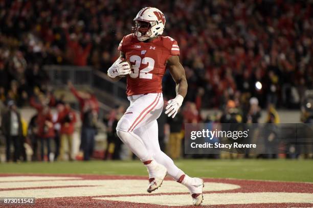 Leon Jacobs of the Wisconsin Badgers returns a fumble for a touchdown during the third quarter of a game against the Iowa Hawkeyes at Camp Randall...